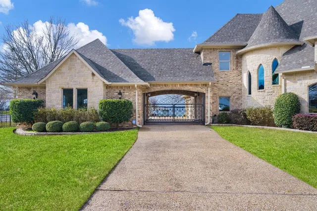 a front view of a house with a garden and yard