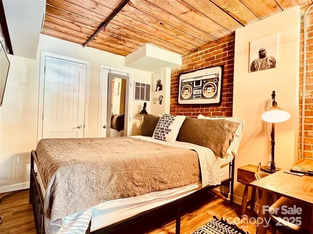 a bed sitting in a bedroom next to a window