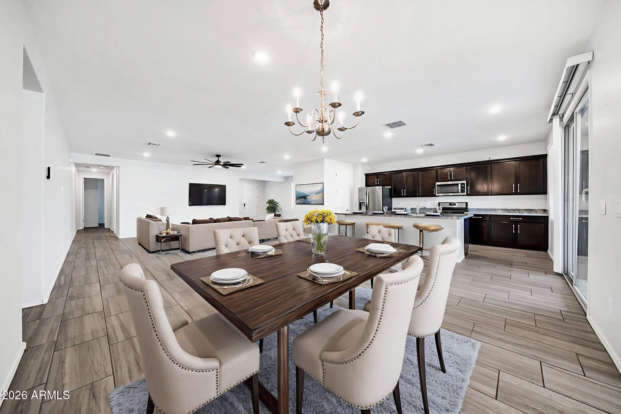 14384 West Hearn Road Surprise, AZ 85379 - Photo 17 of 63 a view of a dining room with furniture and wooden floor