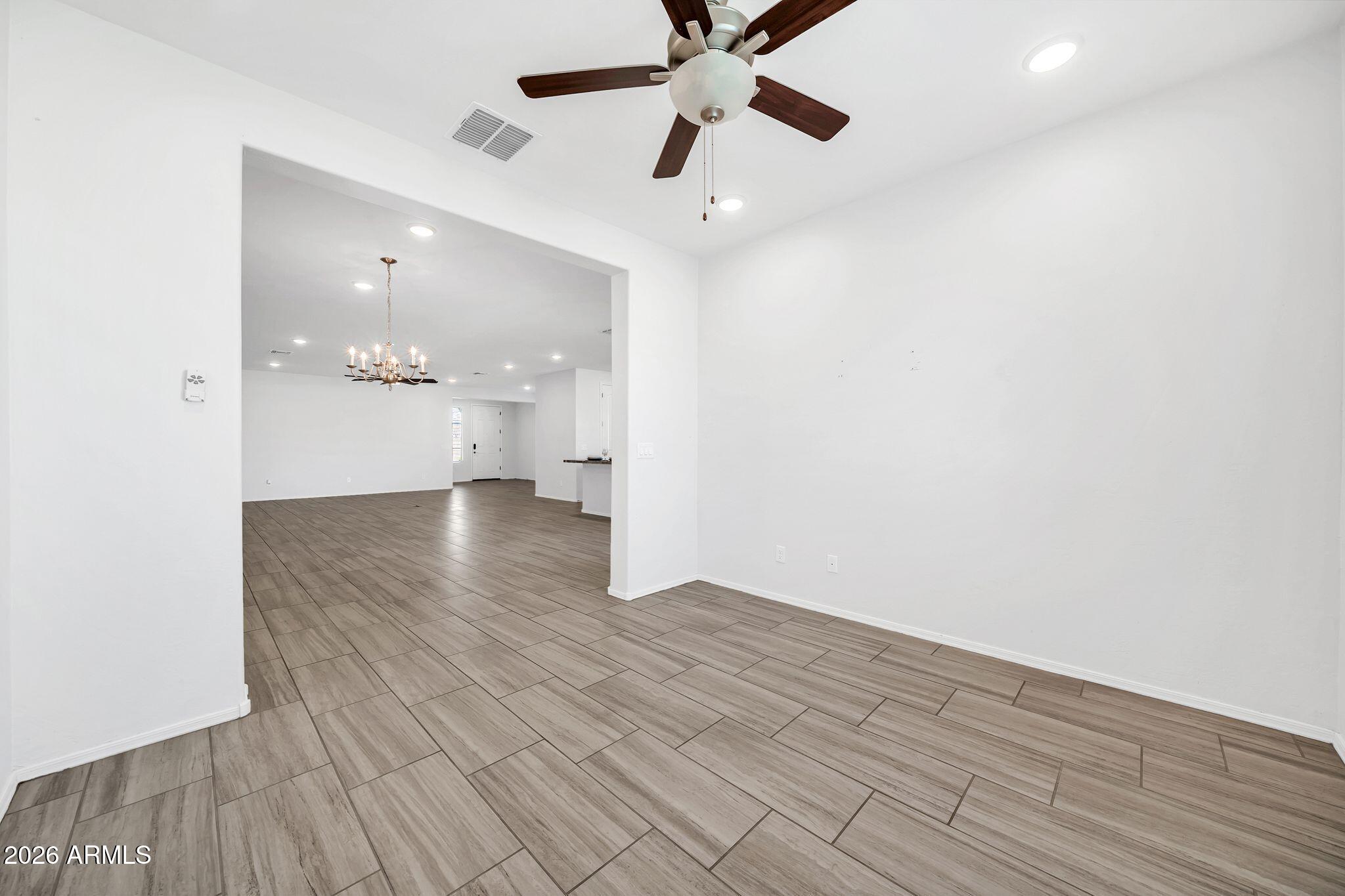 14384 West Hearn Road Surprise, AZ 85379 - Photo 19 of 63 wooden floor in an empty room with a window