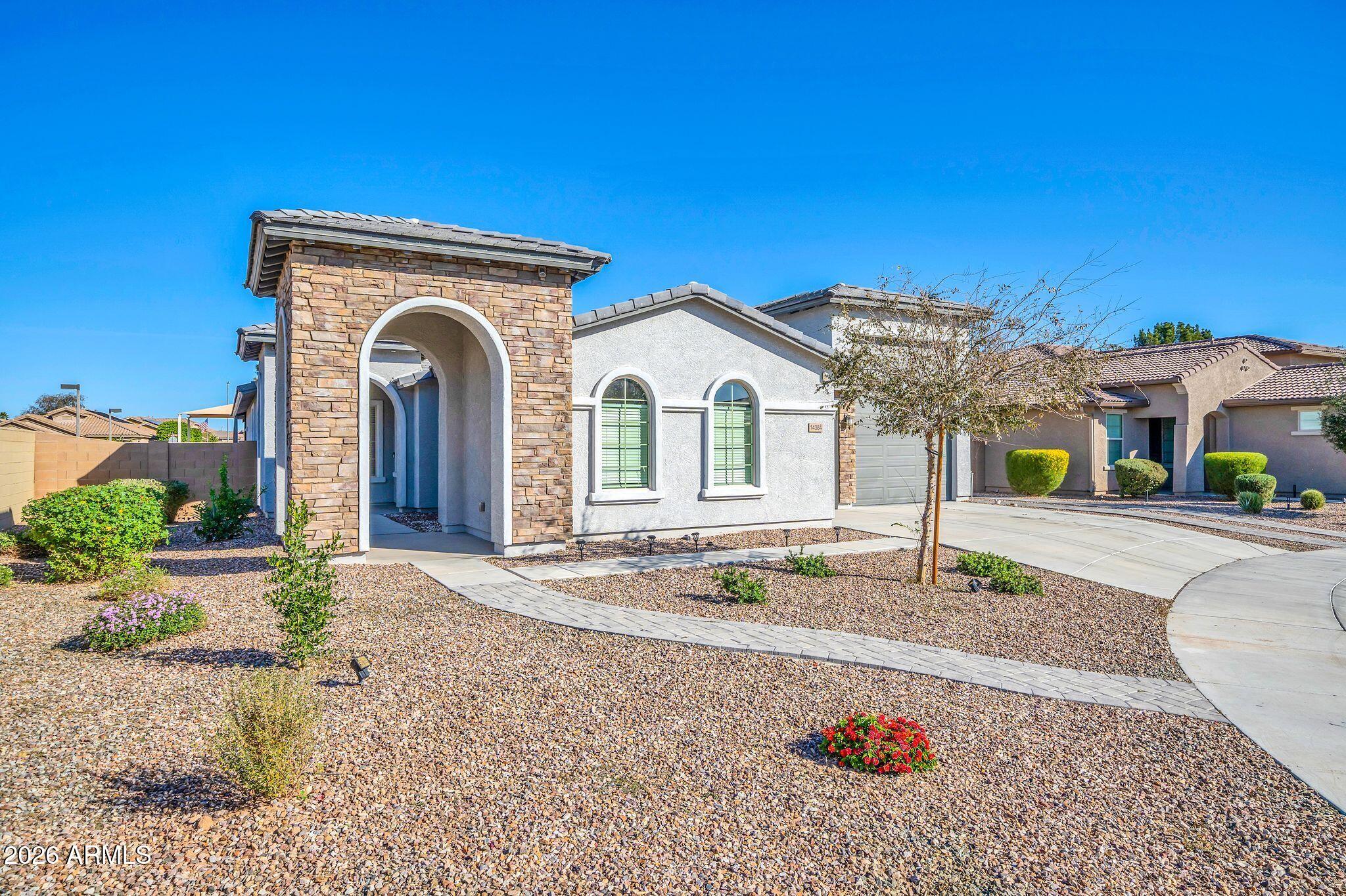 14384 West Hearn Road Surprise, AZ 85379 - Photo 2 of 63 a front view of a house with garden