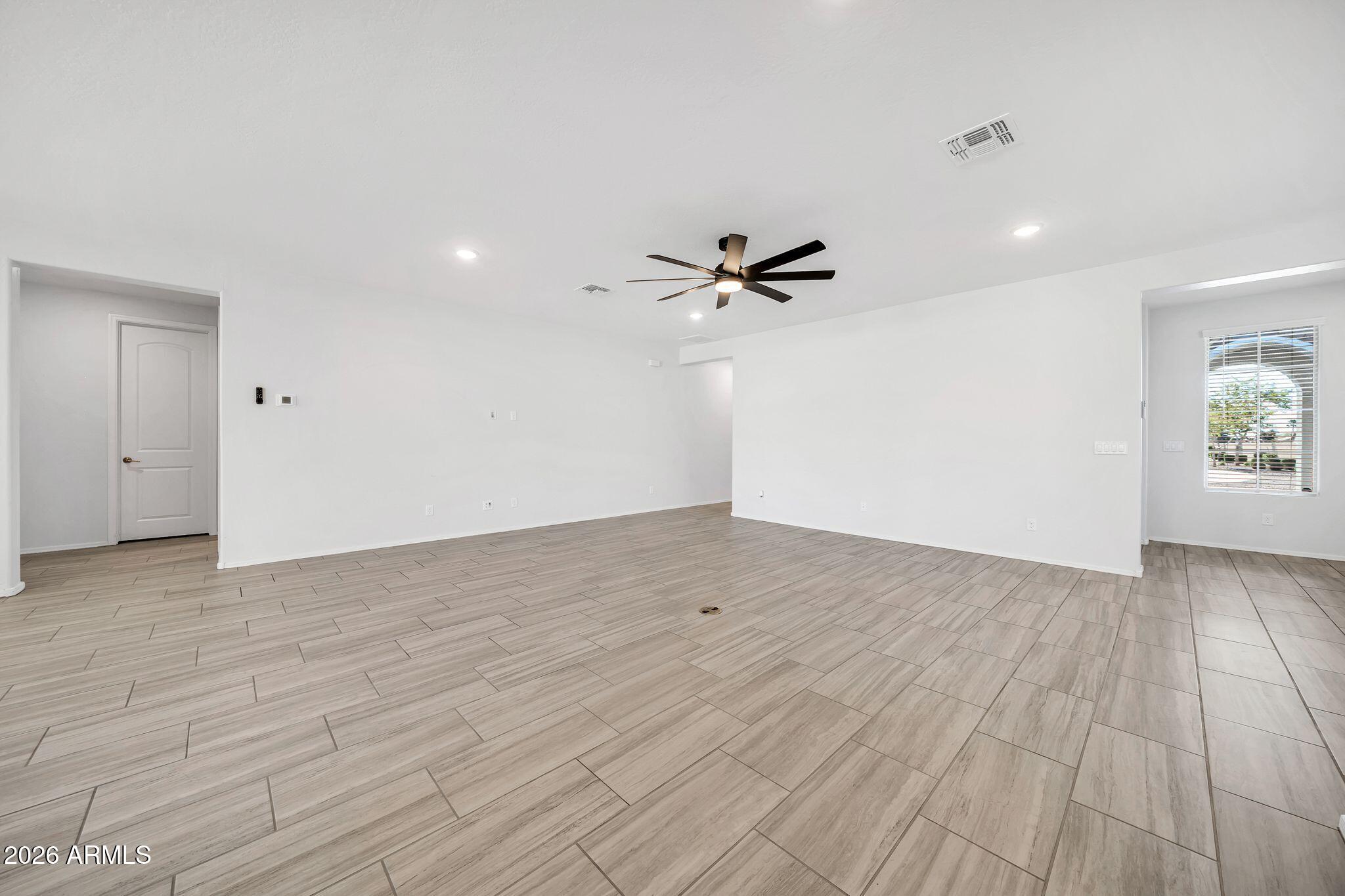 14384 West Hearn Road Surprise, AZ 85379 - Photo 22 of 63 a view of a room with wooden floor and white walls