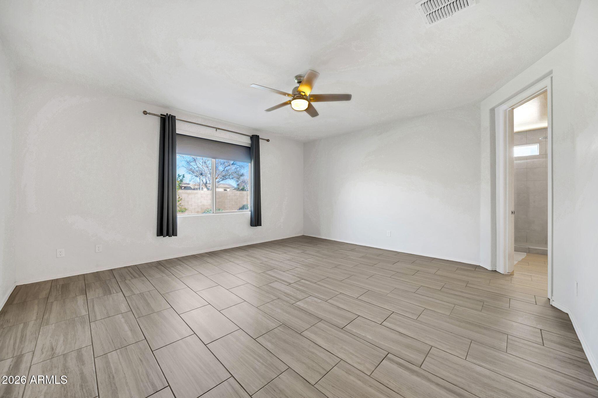 14384 West Hearn Road Surprise, AZ 85379 - Photo 25 of 63 wooden floor in an empty room with a window