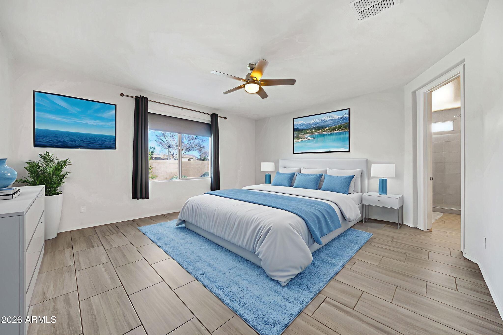 14384 West Hearn Road Surprise, AZ 85379 - Photo 27 of 63 a bedroom with a large bed and a window