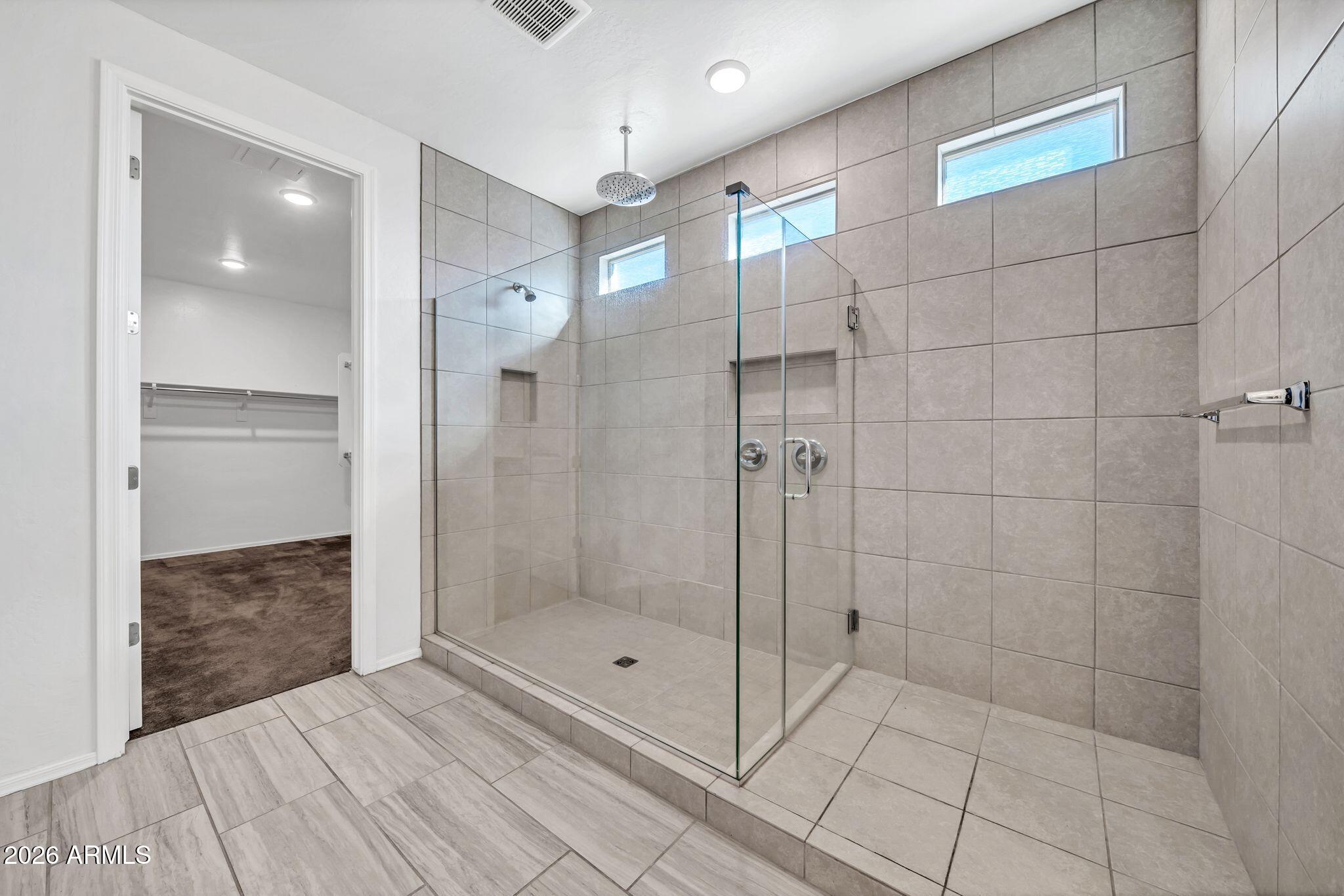 14384 West Hearn Road Surprise, AZ 85379 - Photo 29 of 63 a bathroom with a shower and a mirror