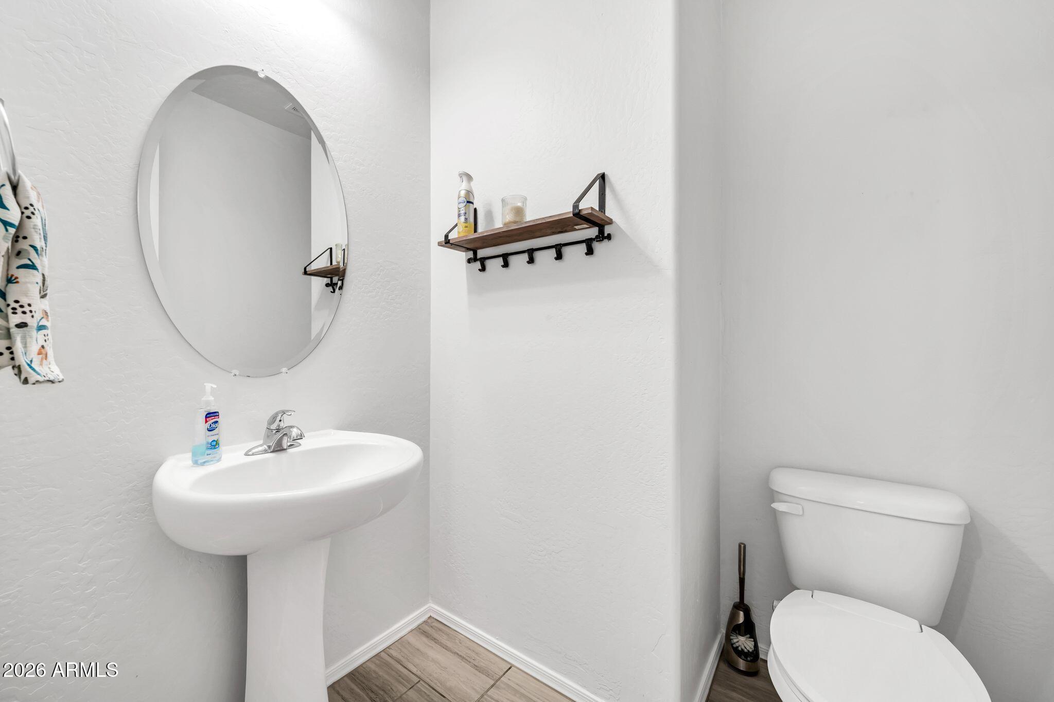 14384 West Hearn Road Surprise, AZ 85379 - Photo 37 of 63 a bathroom with a toilet sink and mirror