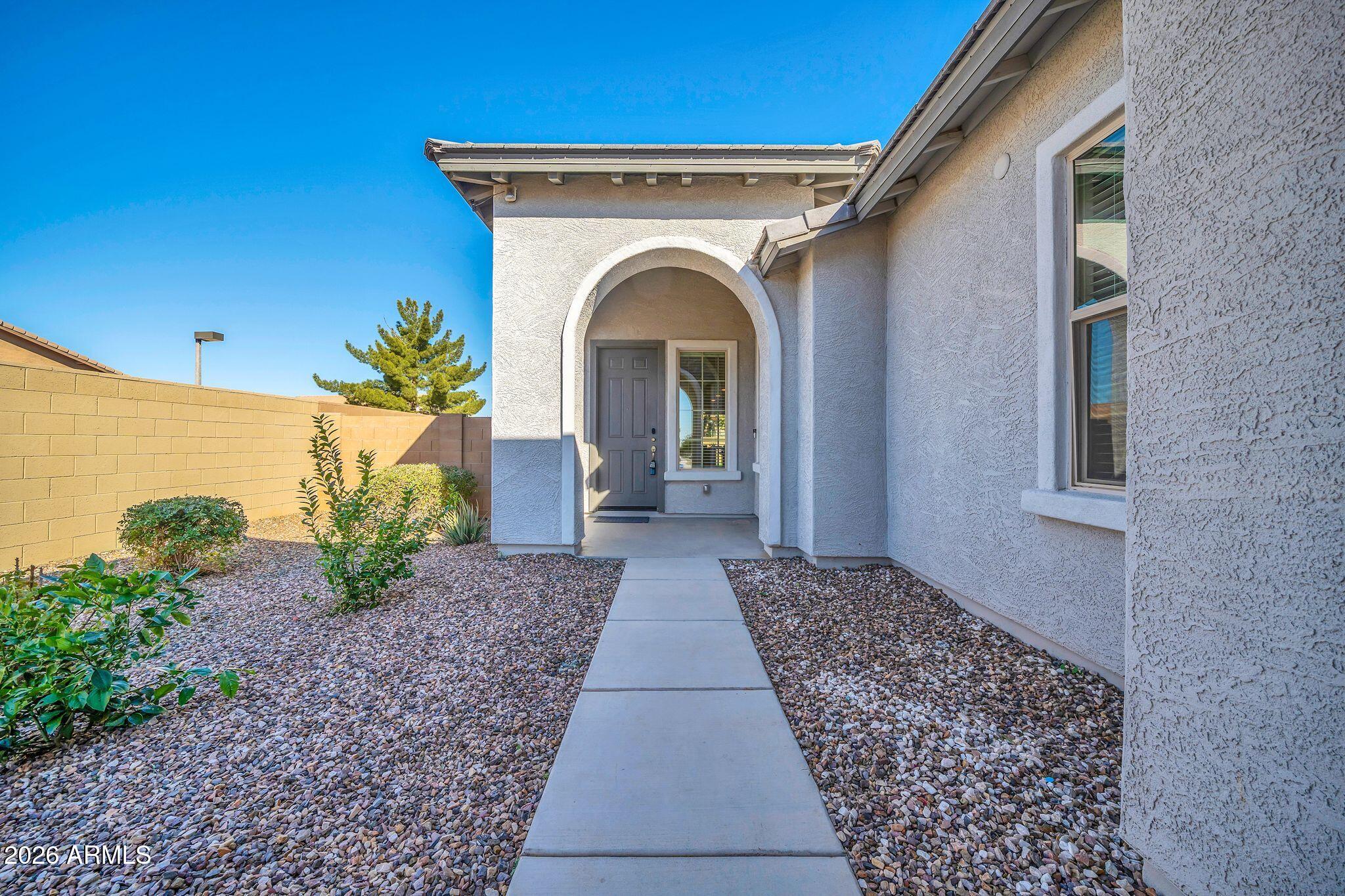 14384 West Hearn Road Surprise, AZ 85379 - Photo 4 of 63 a view of a house with potted plants