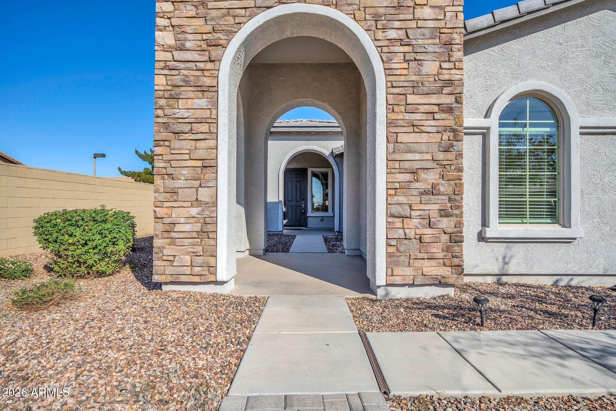 14384 West Hearn Road Surprise, AZ 85379 - Photo 5 of 63 a front view of a house with garden