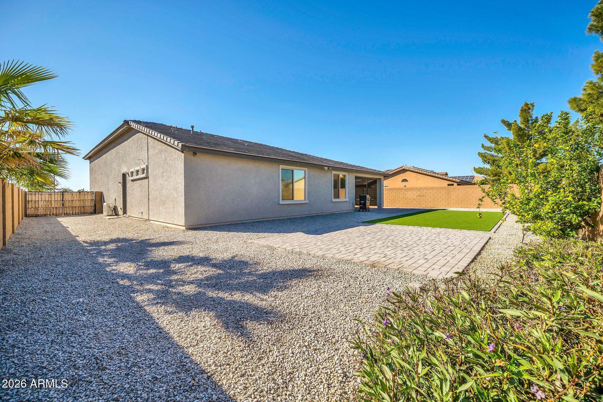 14384 West Hearn Road Surprise, AZ 85379 - Photo 51 of 63 a front view of a house with a yard and garage