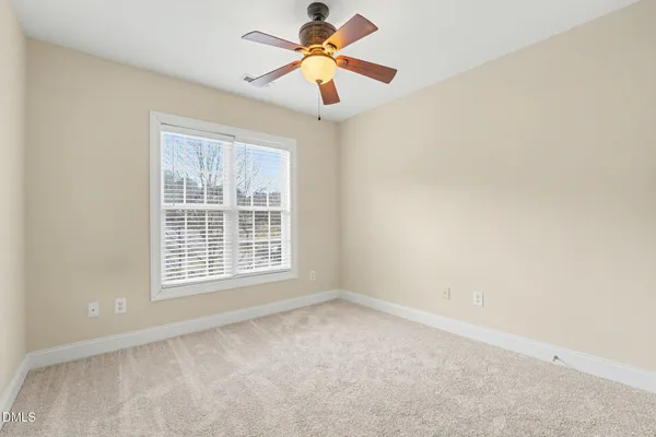 a view of a room with window and a ceiling fan