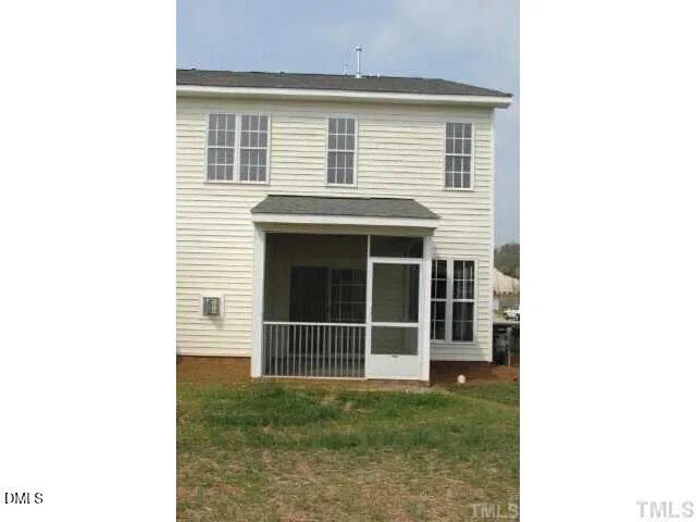 a view of a house with a large window and a yard