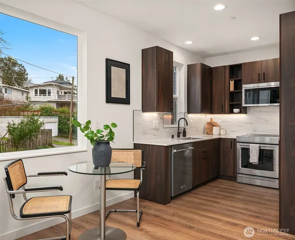 a kitchen with a stove a sink and a refrigerator