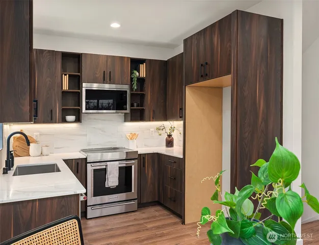 a kitchen with stainless steel appliances a stove a refrigerator and a sink