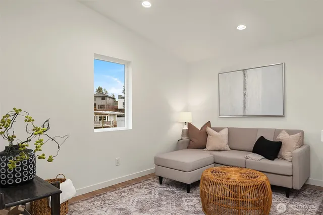 a living room with furniture and a potted plant