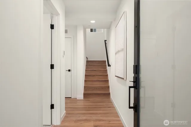 a view of a hallway with stairs and a hallway