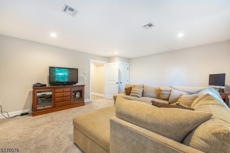 6 Elm Street, Unit 10 Madison, NJ 07940 - Photo 9 of 15 a living room with furniture and a flat screen tv