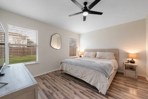 a bedroom with a bed and a window
