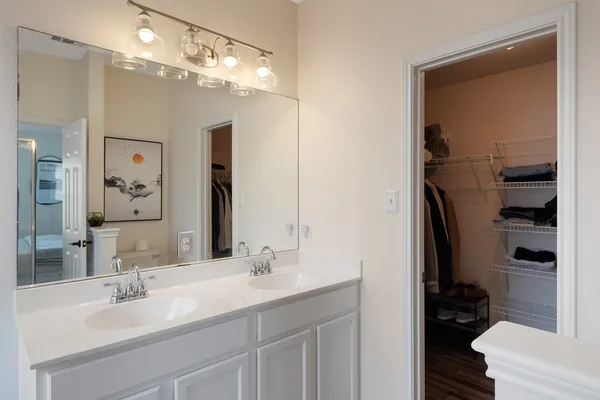 a bathroom with a sink double vanity and a mirror