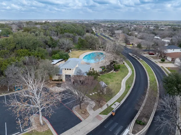 an aerial view of a house with a swimming pool