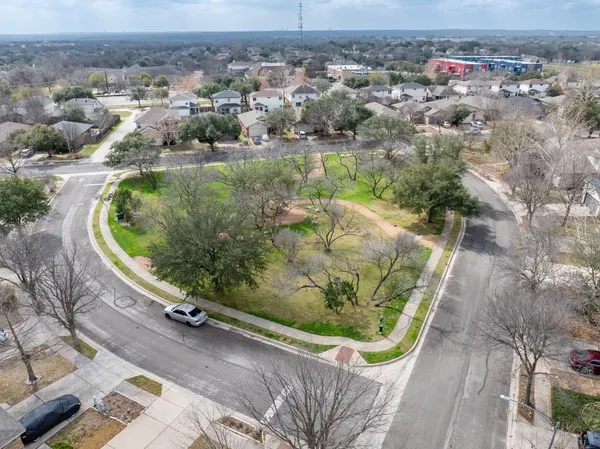 an aerial view of a house with a yard and lake view