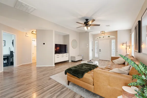 a spacious bedroom with a bed and a chandelier