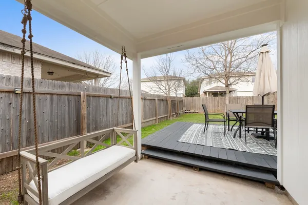 a bed sitting in a balcony next to a yard