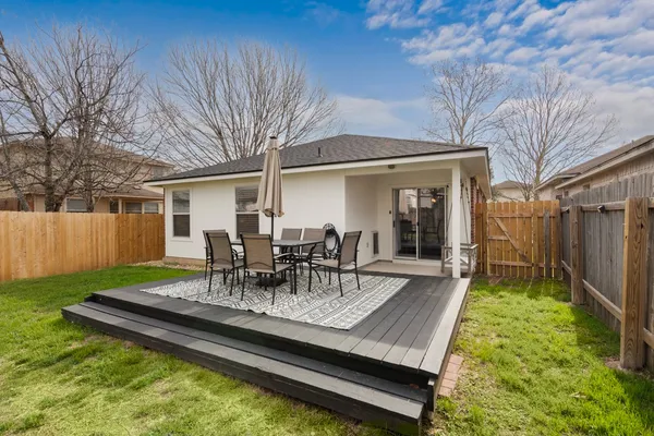 a view of a backyard with table and chairs