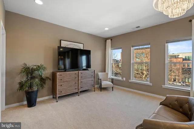 a view of a bedroom with furniture and window