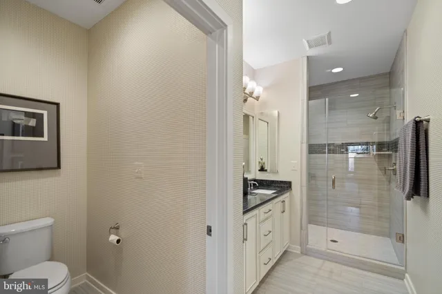 a living room with lots of furniture and kitchen view