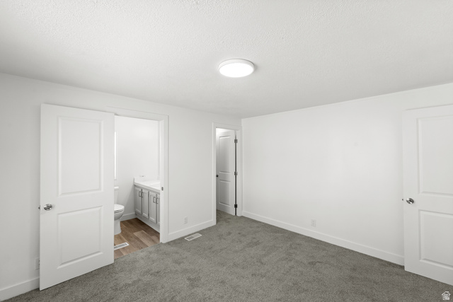 2600 North Hill Field Road, Unit 103A Layton, UT 84041 - Photo 14 of 31 Spacious room featuring neutral carpeting, white walls, and a flush-mount ceiling light