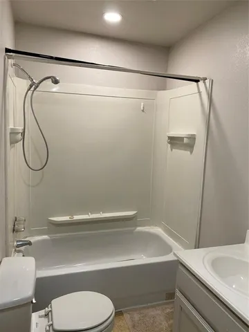 a bathroom with a shower a toilet and a sink