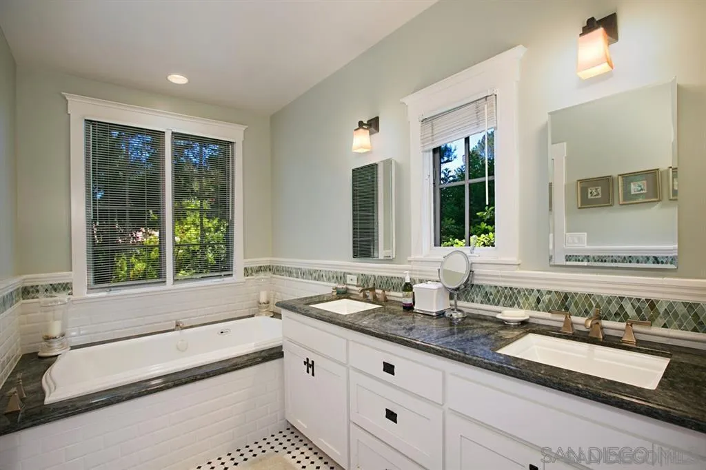 16348 Orchard Bend Road Poway, CA 92064 - Photo 5 of 23 a bathroom with double vanity sinks and a bathtub