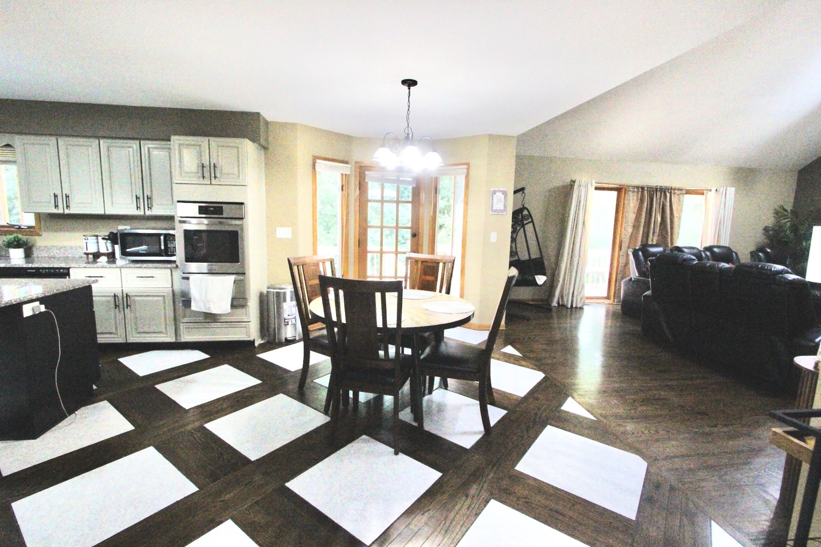 6 Allegheny Court Bolingbrook, IL 60440 - Photo 12 of 38 a dining room with wooden floor a chandelier a wooden table and chairs