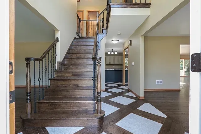 a view of entryway and hall with wooden floor