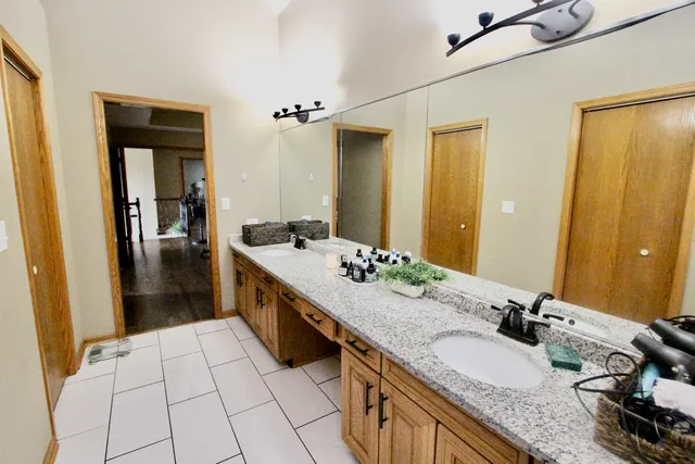 a bedroom with bed and wooden floor