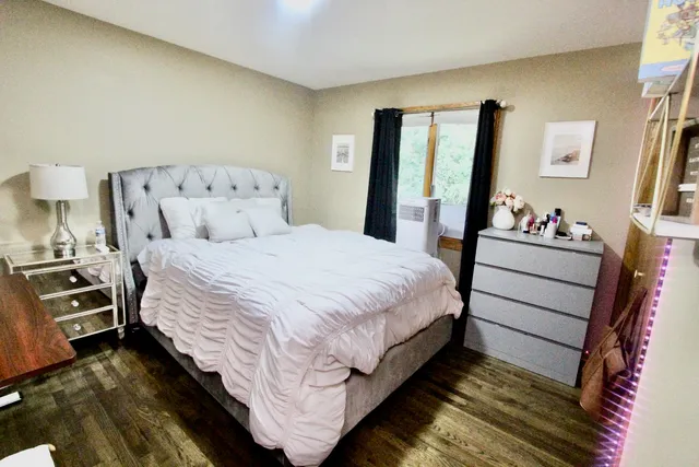 a view of a house with a tree and a yard