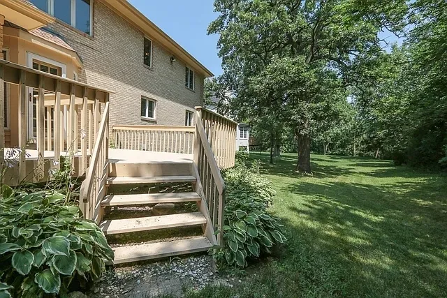 a view of balcony with wooden floor and fence