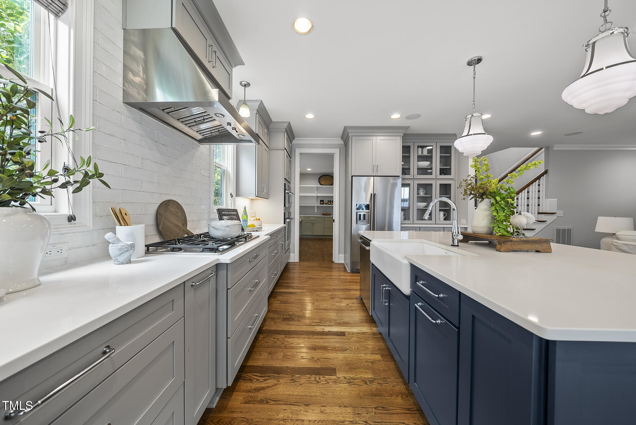 1306 Mordecai Drive Raleigh, NC 27604 - Photo 17 of 78 a large kitchen with stainless steel appliances kitchen island granite countertop a sink a counter space and a view of living room