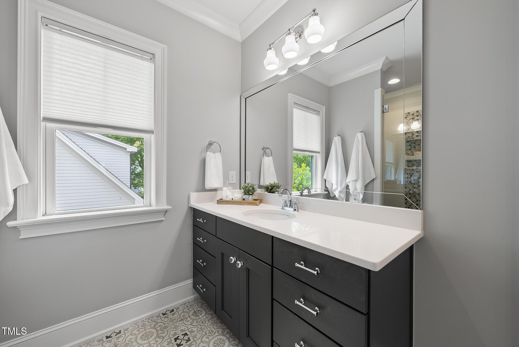 1306 Mordecai Drive Raleigh, NC 27604 - Photo 34 of 78 a bathroom with a sink a vanity and a mirror
