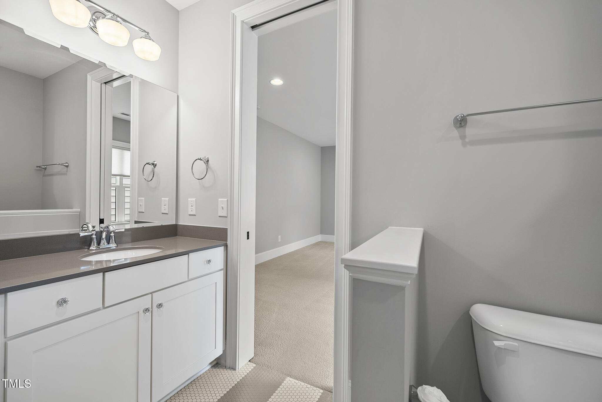 1306 Mordecai Drive Raleigh, NC 27604 - Photo 41 of 78 a bathroom with a granite countertop sink a toilet and a mirror
