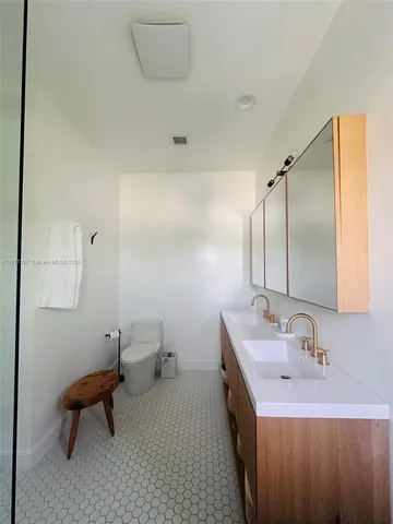 a kitchen with stainless steel appliances a sink a stove a refrigerator a counter top space and cabinets