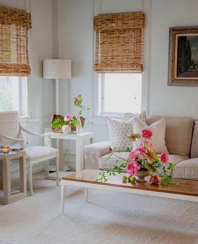 a living room filled with furniture and flowers