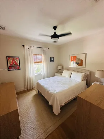 a bedroom with a bed and a night stand