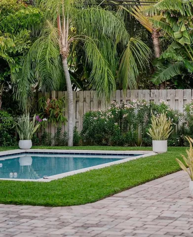 a couple of potted plants in front of a door