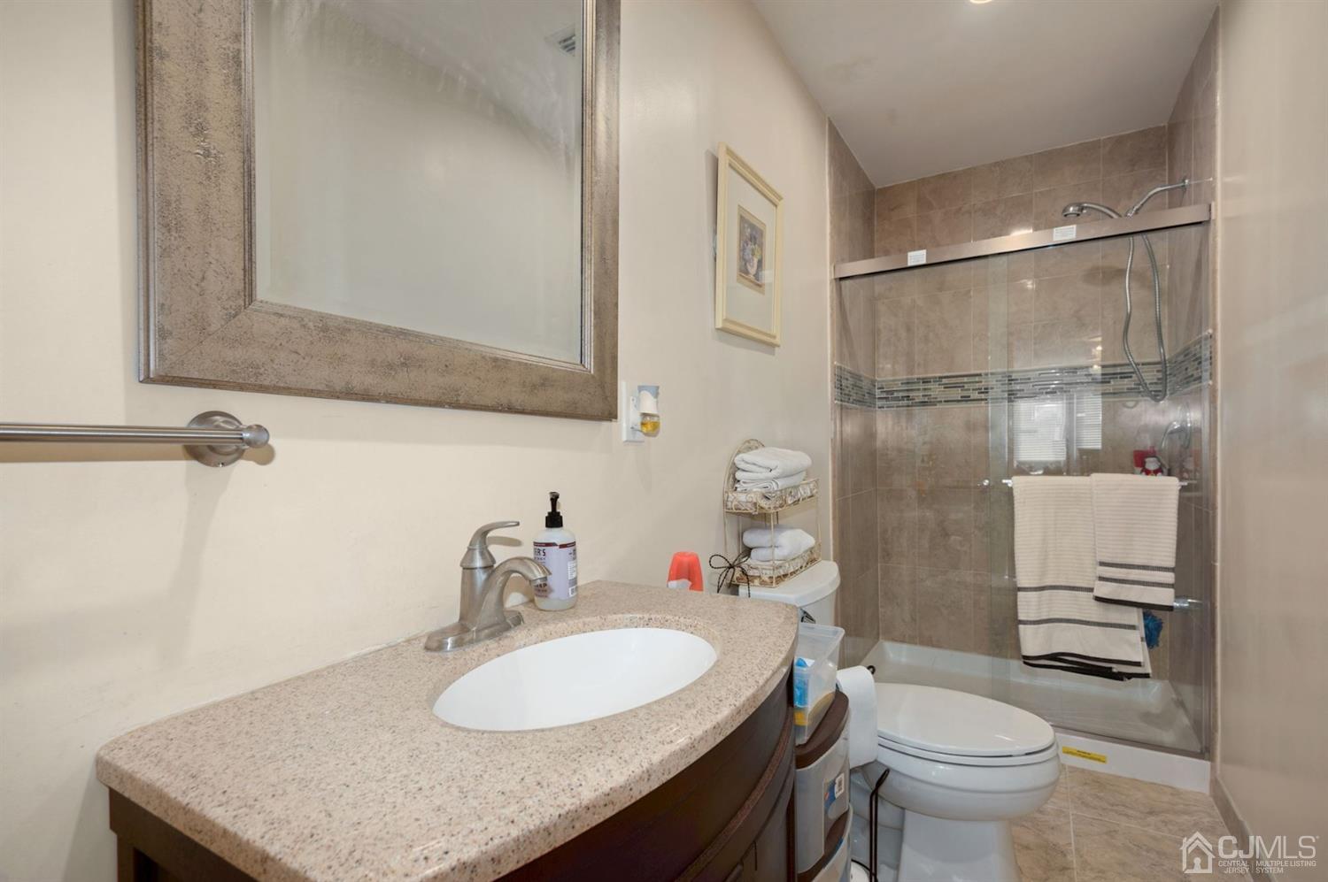 24 Partch Place Edison, NJ 08817 - Photo 14 of 22 a bathroom with a granite countertop sink toilet and a mirror