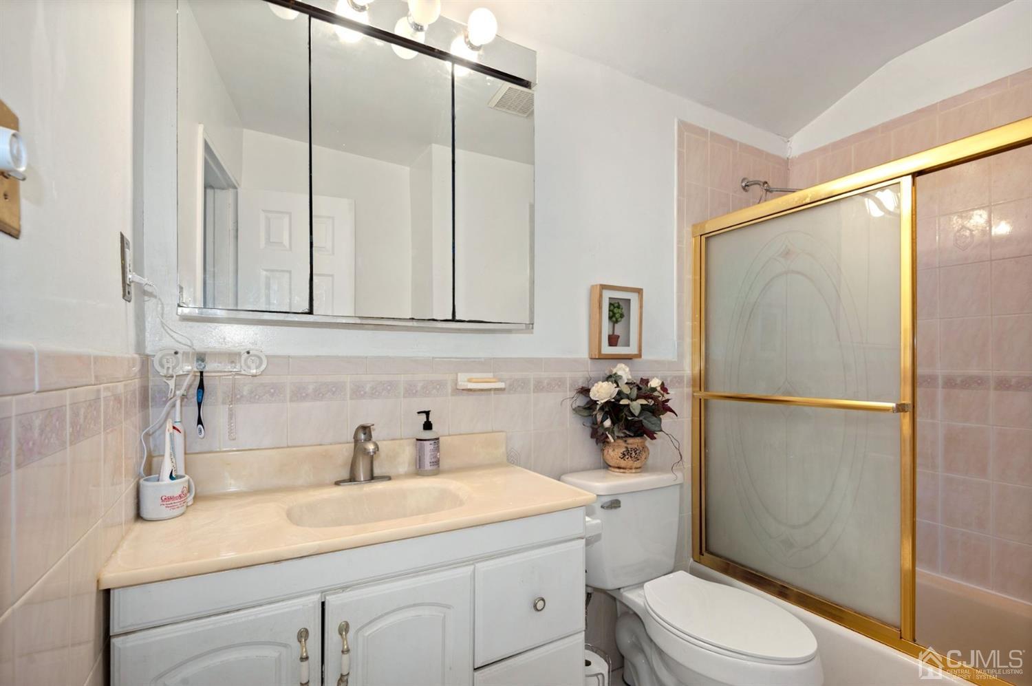 24 Partch Place Edison, NJ 08817 - Photo 15 of 22 a bathroom with a sink a toilet and shower
