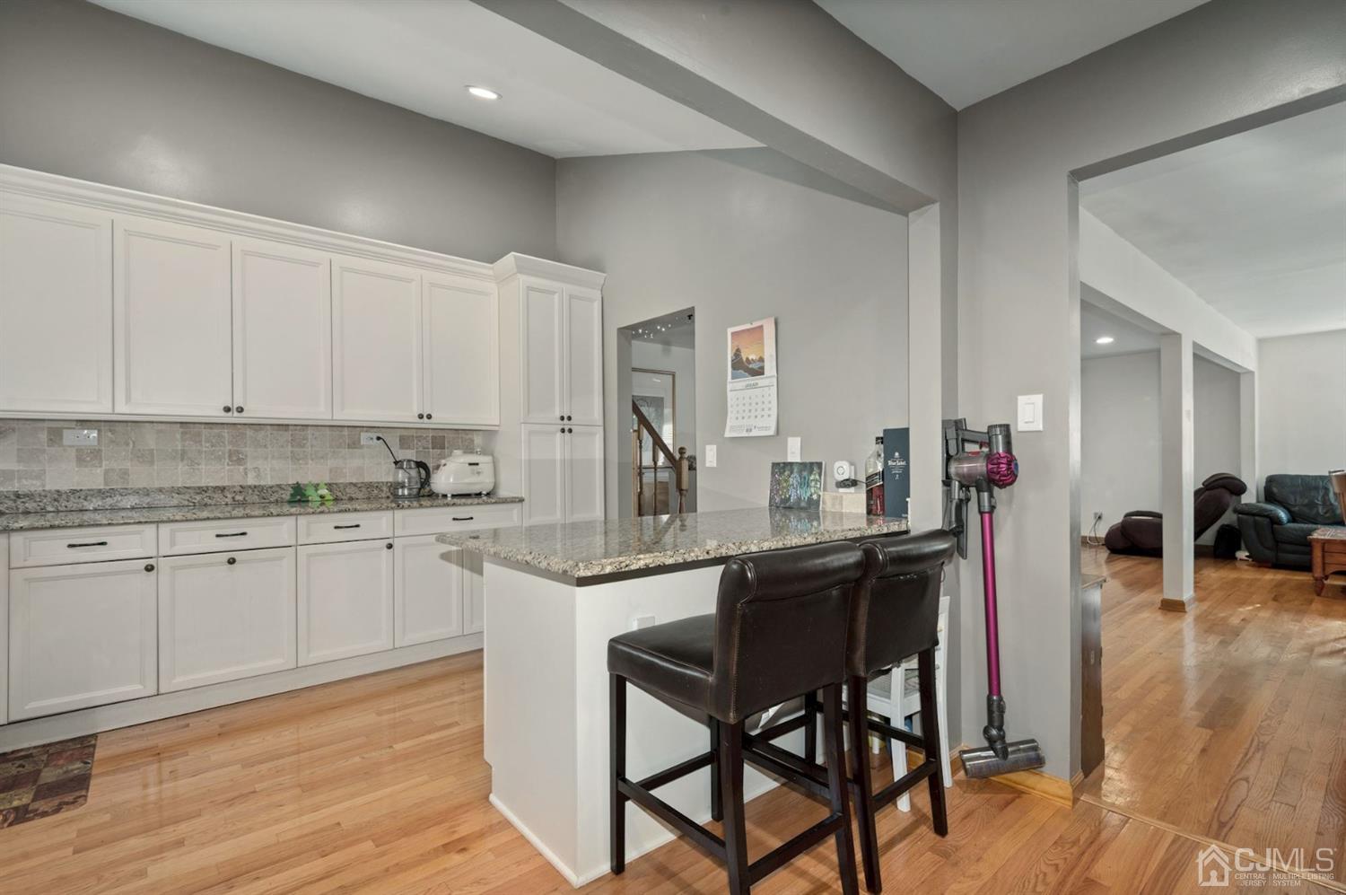 24 Partch Place Edison, NJ 08817 - Photo 3 of 22 a kitchen with a sink cabinets and wooden floor