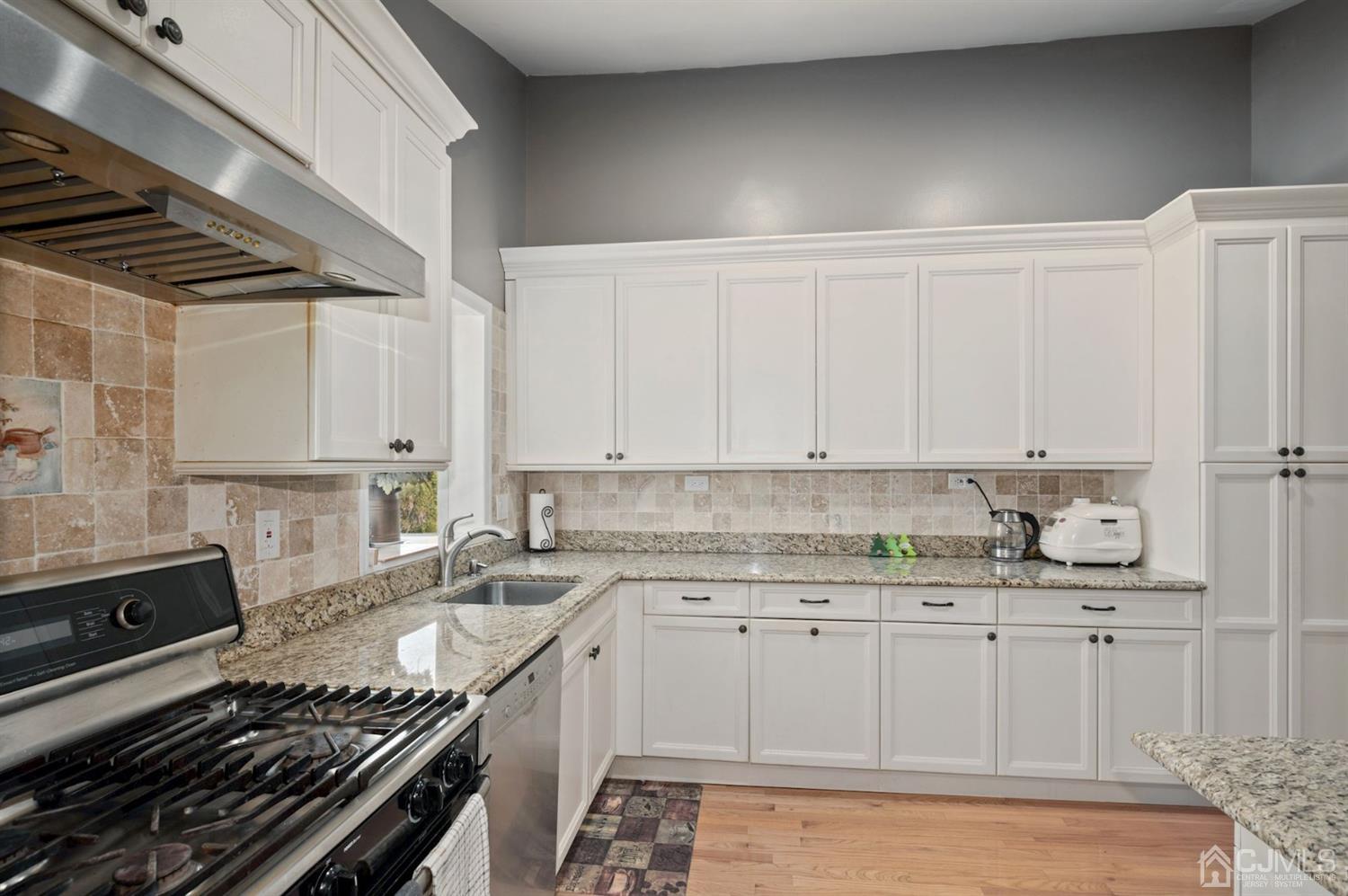 24 Partch Place Edison, NJ 08817 - Photo 4 of 22 a kitchen with a sink stove and cabinets