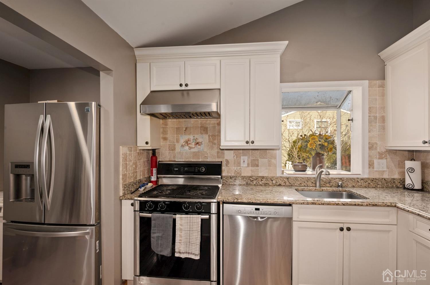 24 Partch Place Edison, NJ 08817 - Photo 5 of 22 a kitchen with appliances a sink and a window