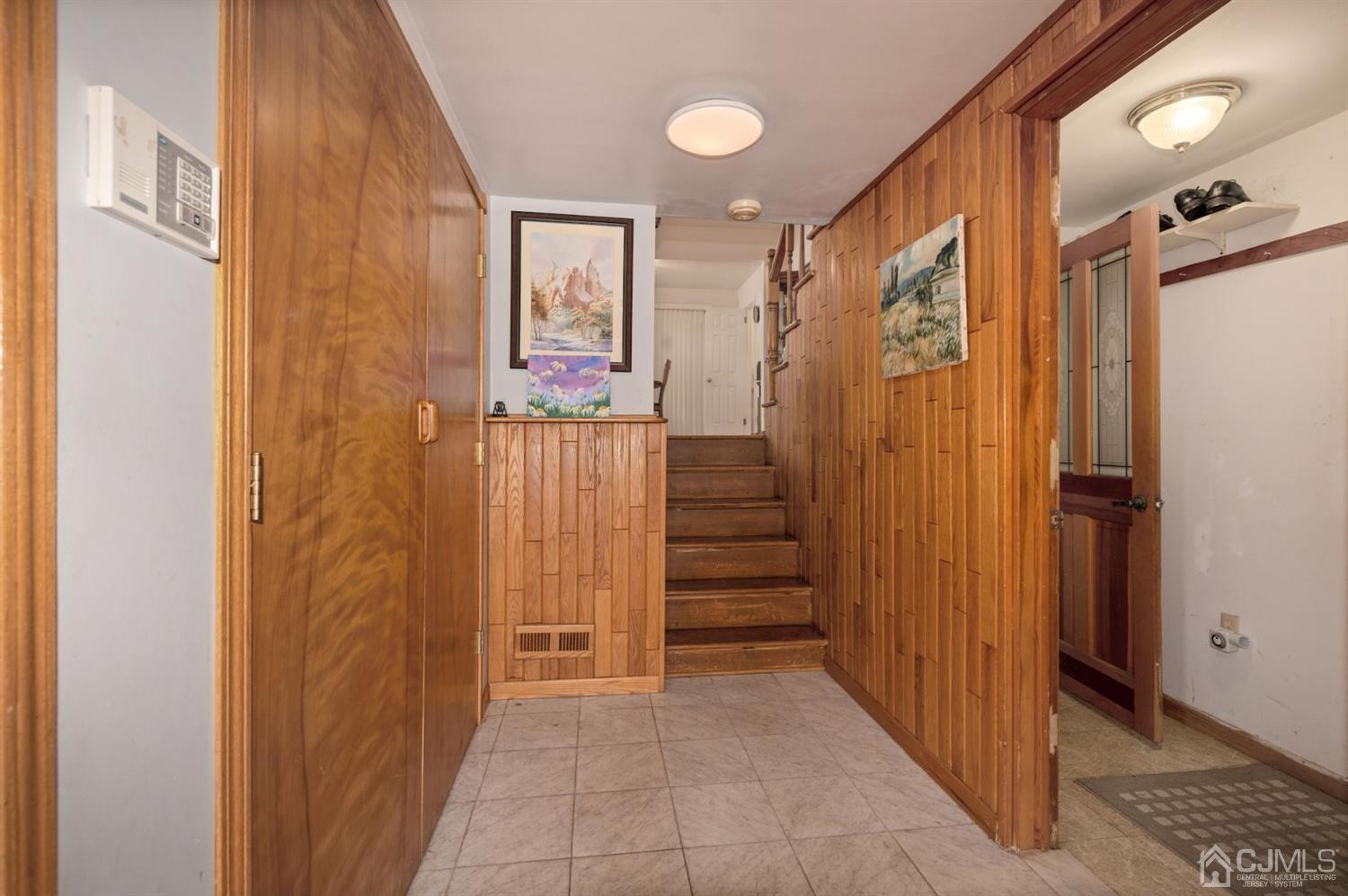 24 Partch Place Edison, NJ 08817 - Photo 8 of 22 a view of a hallway with wooden cabinets and staircase